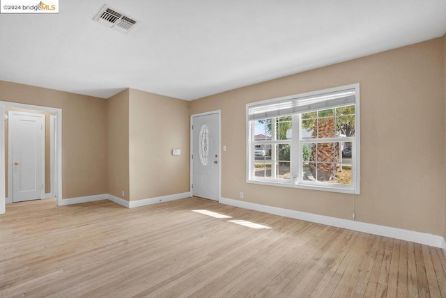 spare room with light hardwood / wood-style floors