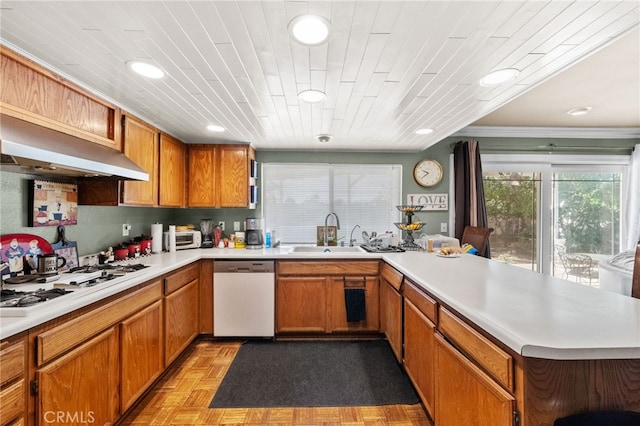 kitchen featuring exhaust hood, light parquet flooring, dishwashing machine, white gas cooktop, and crown molding