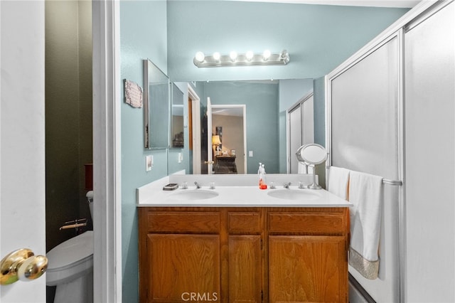 bathroom featuring toilet and vanity