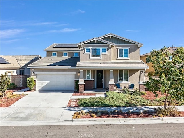 craftsman inspired home with covered porch, solar panels, and a garage