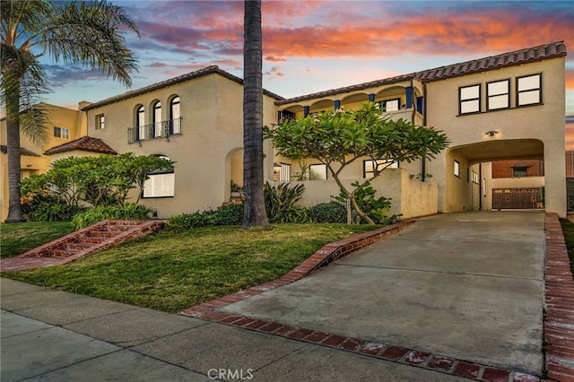 mediterranean / spanish-style home with a yard