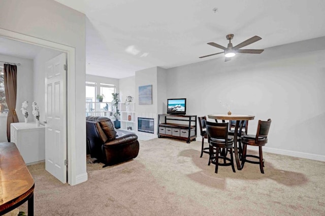 interior space featuring ceiling fan and light carpet