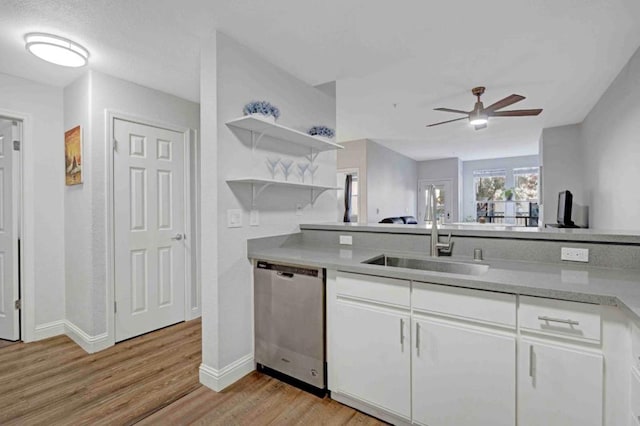 kitchen featuring white cabinetry, dishwasher, sink, and light wood-type flooring