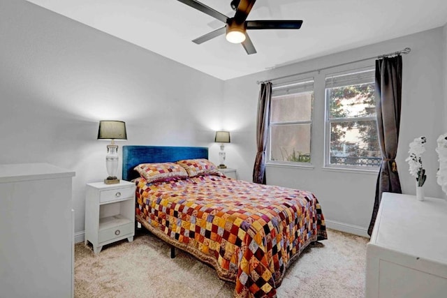 bedroom with light carpet and ceiling fan