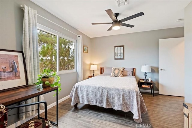 bedroom with ceiling fan and wood-type flooring