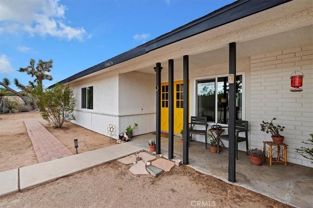 property entrance featuring a patio