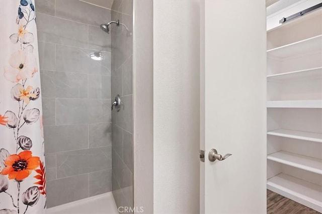 bathroom with hardwood / wood-style floors and curtained shower