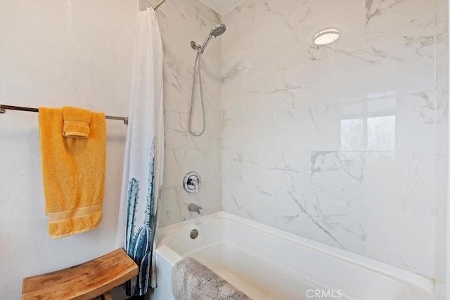 bathroom with shower / tub combo with curtain