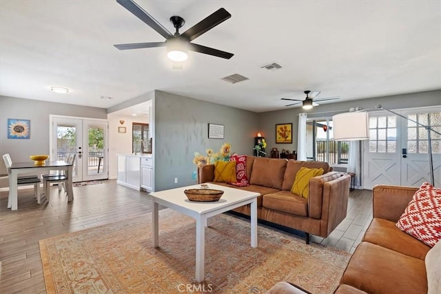 living room with ceiling fan and french doors