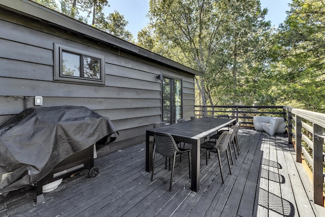 wooden terrace with a grill