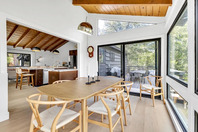 dining space with wood ceiling, light hardwood / wood-style flooring, and plenty of natural light