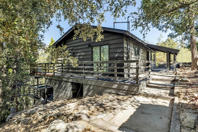 view of side of home featuring a wooden deck