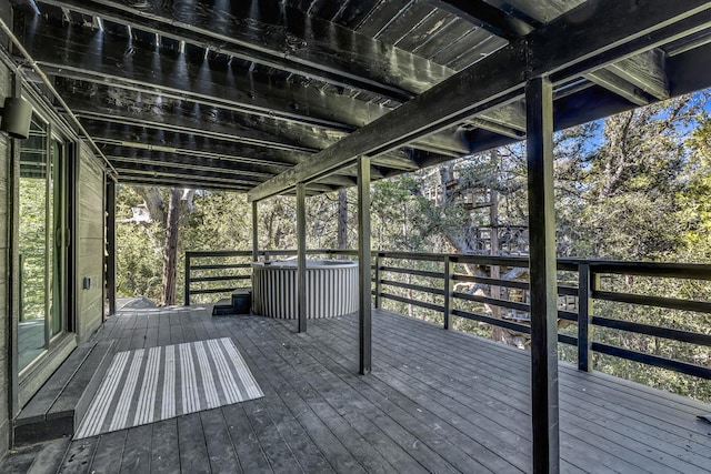 wooden deck with a hot tub