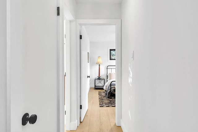 corridor with light hardwood / wood-style flooring