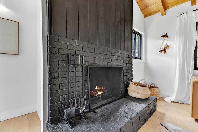 interior details with beamed ceiling, hardwood / wood-style flooring, a fireplace, and wooden ceiling