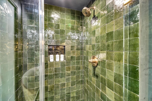 bathroom with a tile shower