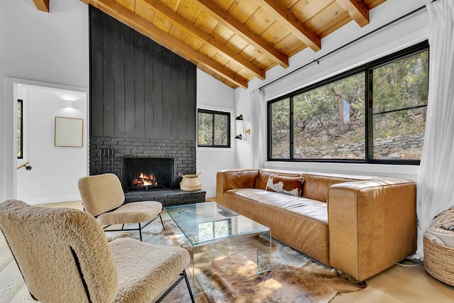 living room with beam ceiling, wood ceiling, a fireplace, and high vaulted ceiling