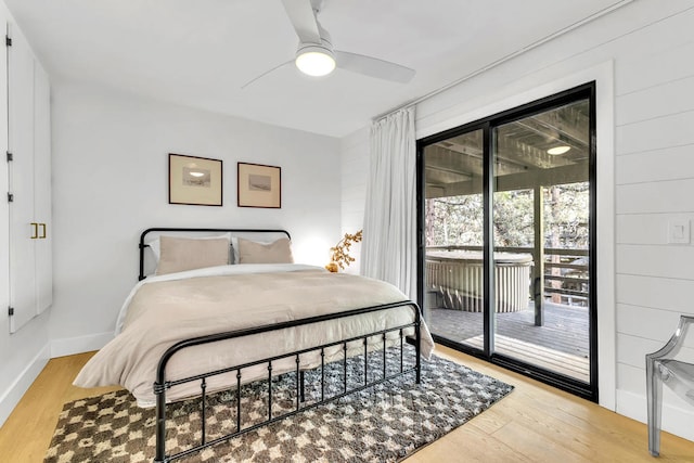 bedroom with light hardwood / wood-style floors, access to outside, and ceiling fan