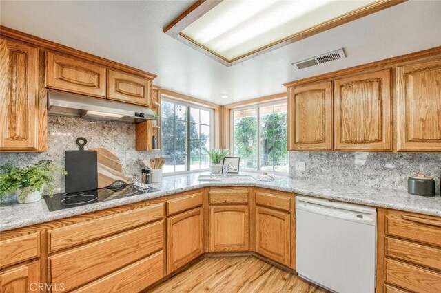 18486 Tollhouse Rd, Clovis, CA 93619 - kitchen featuring white dishwasher, under cabinet range hood, black electric cooktop, and tasteful backsplash