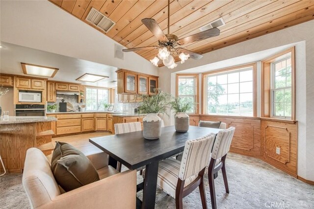 18486 Tollhouse Rd, Clovis, CA 93619 - dining room featuring lofted ceiling, wood ceiling, ceiling fan, and light colored carpet