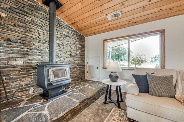 18486 Tollhouse Rd, Clovis, CA 93619 - carpeted living area featuring a wood stove, wooden ceiling, and lofted ceiling