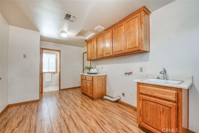 18486 Tollhouse Rd, Clovis, CA 93619 - washroom with cabinet space, light wood-type flooring, washer hookup, hookup for an electric dryer, and baseboards