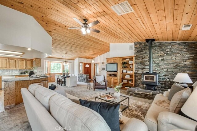18486 Tollhouse Rd, Clovis, CA 93619 - living area with wood ceiling, ceiling fan, light carpet, a wood stove, and high vaulted ceiling