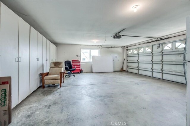 18486 Tollhouse Rd, Clovis, CA 93619 - garage with freestanding refrigerator and a garage door opener
