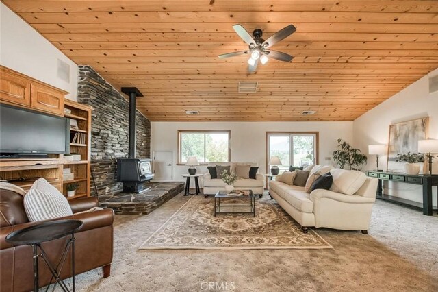 18486 Tollhouse Rd, Clovis, CA 93619 - carpeted living area featuring wooden ceiling, vaulted ceiling, a wood stove, and a ceiling fan