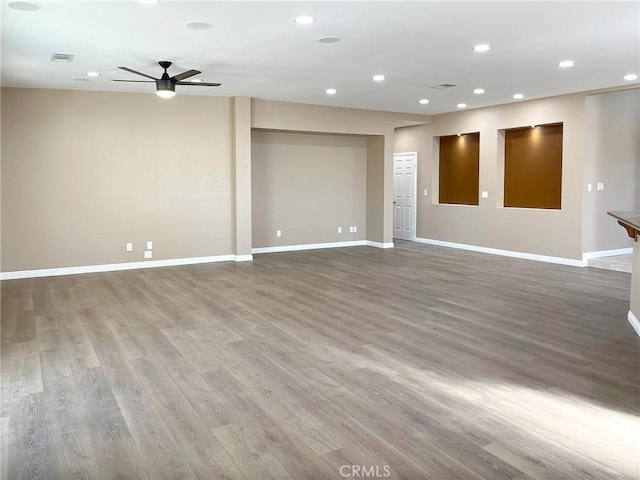 spare room featuring recessed lighting, visible vents, and baseboards