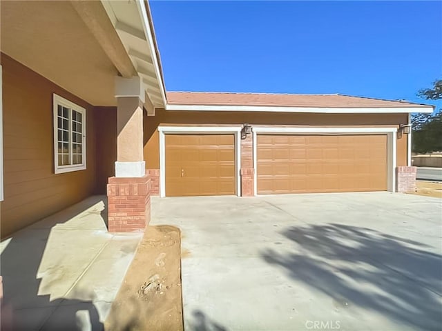 garage featuring concrete driveway