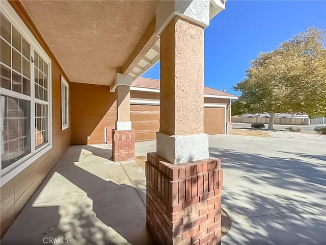 view of patio with driveway and a garage