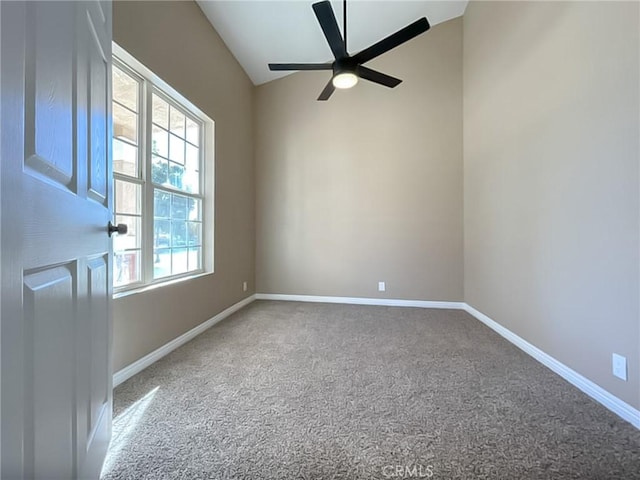 carpeted empty room featuring a ceiling fan and baseboards