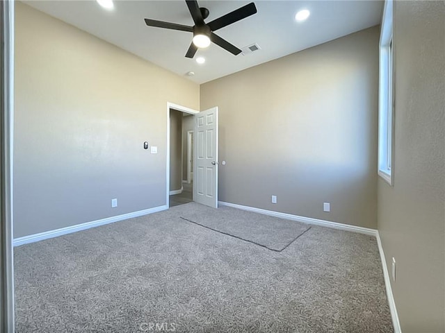 empty room featuring ceiling fan and carpet flooring