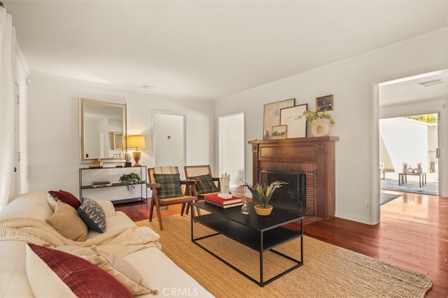 living room with a fireplace and hardwood / wood-style flooring