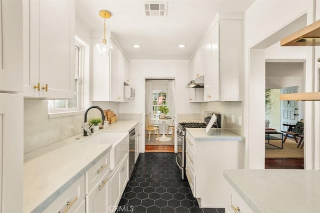 kitchen featuring pendant lighting, white cabinets, stainless steel appliances, and dark wood-type flooring