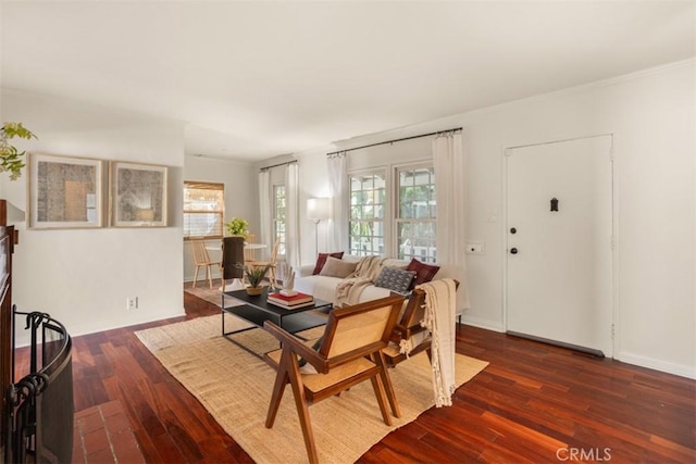 living room with dark hardwood / wood-style floors and crown molding