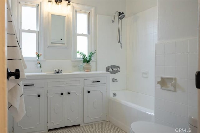 full bathroom with vanity, tile patterned floors, a wealth of natural light, and  shower combination