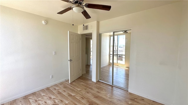 unfurnished bedroom with a closet, ceiling fan, and light wood-type flooring