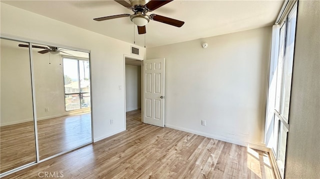 unfurnished bedroom with a closet, ceiling fan, and light hardwood / wood-style flooring