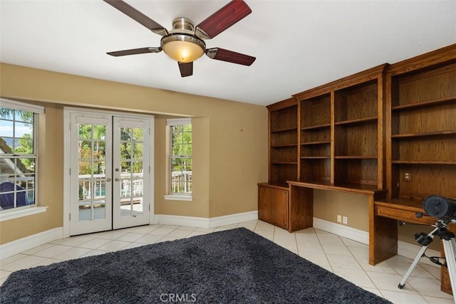 unfurnished office featuring a wealth of natural light, french doors, light tile patterned floors, and ceiling fan