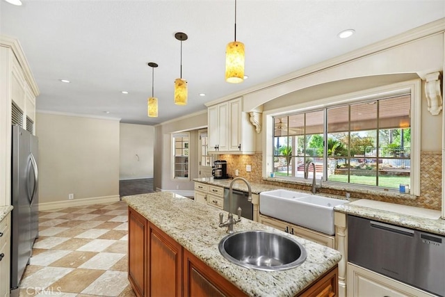 kitchen with stainless steel refrigerator, hanging light fixtures, crown molding, and sink