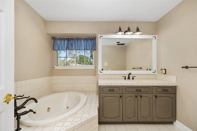 bathroom with vanity and tiled tub