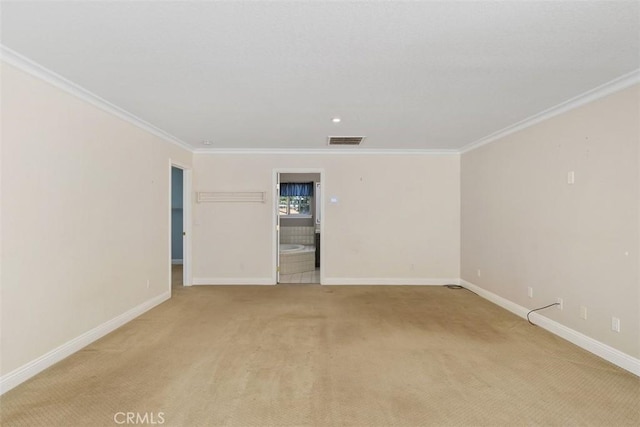 carpeted empty room featuring crown molding