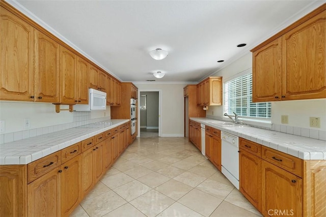 kitchen featuring tile counters, sink, white appliances, and ornamental molding