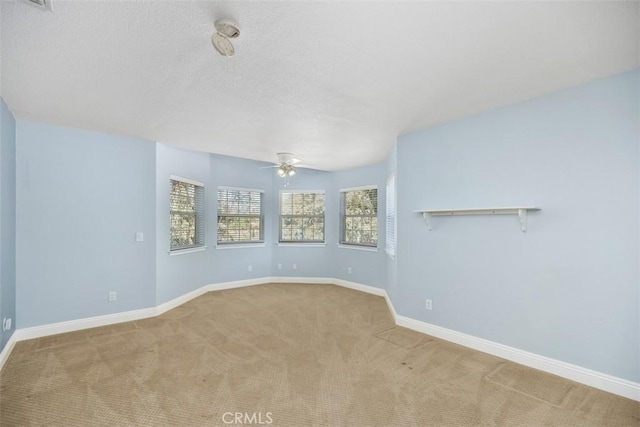 unfurnished room with light carpet and ceiling fan