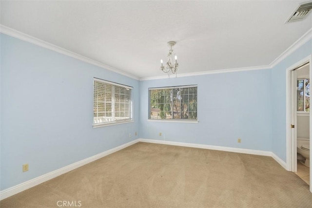 carpeted empty room featuring ornamental molding and a notable chandelier