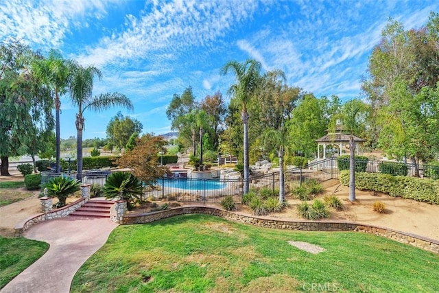 view of community featuring a lawn and a pool