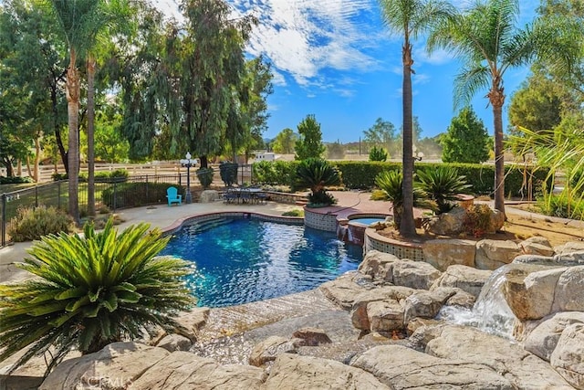 view of pool featuring an in ground hot tub and a patio