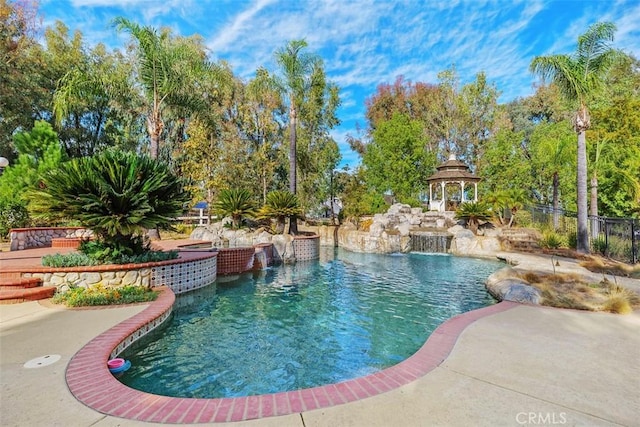 view of pool with a gazebo and pool water feature